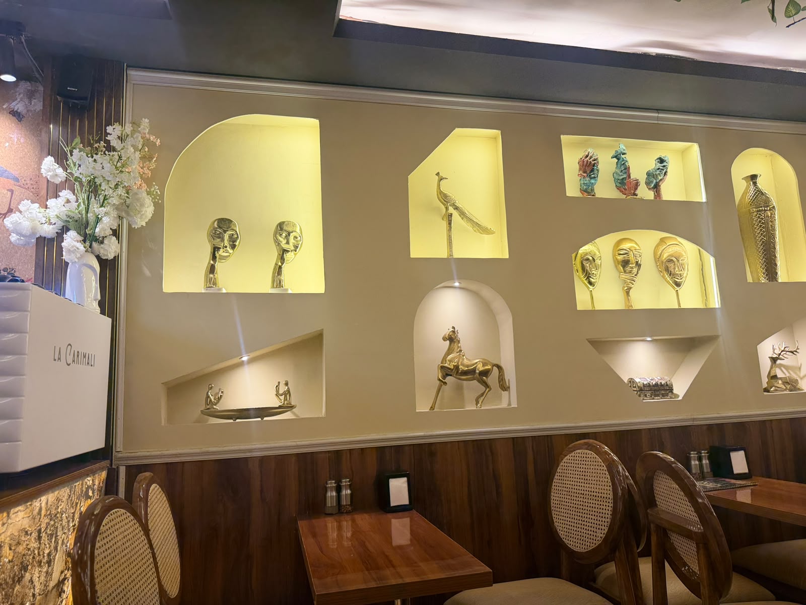 Golden brass sculptures displayed in wall niches